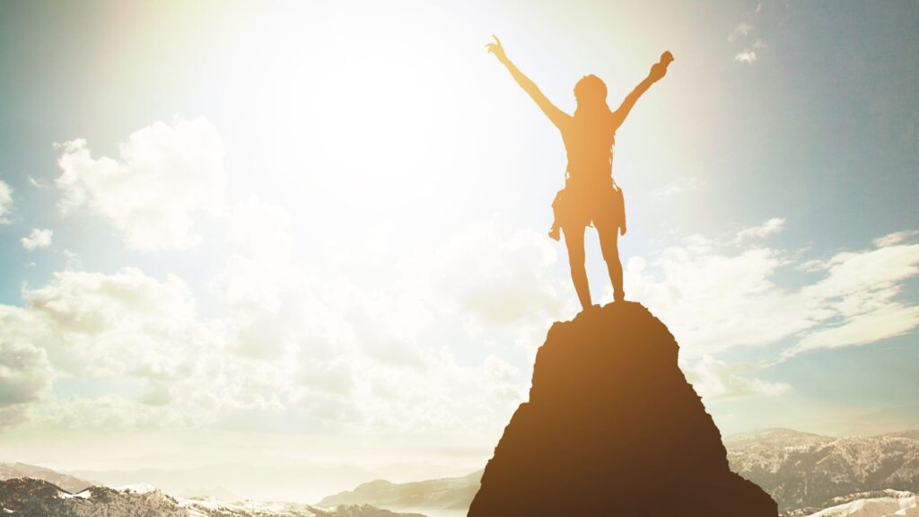 Smiling woman looking toward sunrise, symbolizing self-worth and new beginnings.
